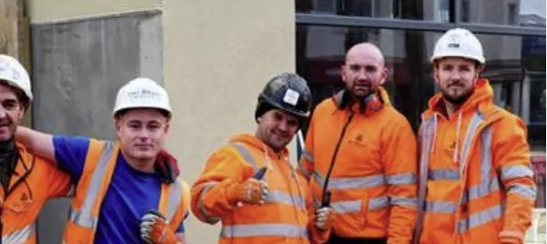 The SMJ Brady site team on a town-centre project, in hi-vis and hard hats